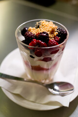 A glass of vacherin with Whipped Cream and Mixed Berries. Soft focus image.