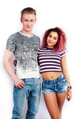young pretty teenage couple, hipster blond guy with his mixed raced girlfriend happy smiling and hugging isolated on white background, lifestyle people concept