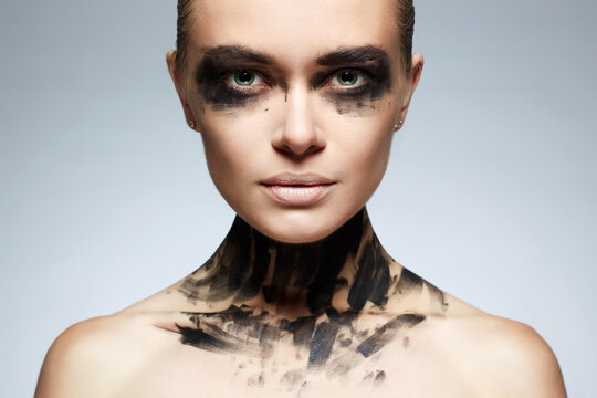 portrait of Beautiful Young woman with Paint Face