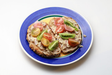 Baby tomatoes tuna mayonnaise mixed salad on toasted brown sandwich bread