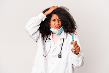 Young african american curly doctor woman holding a syringe being shocked, she has remembered important meeting.