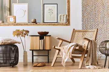 Unique living room interior with stylish rattan armchair, design furniture, dried flowers, mock up poster frames, wooden floor, decoration and elegant personal accessories. Modern home. Template.
