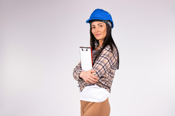 Portrait of a female engineer in a blue helmet with a folder looks in a cameo. White background...