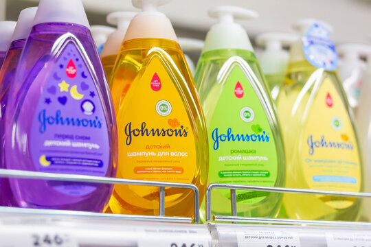 Russia Samara November 2019: Johnson's baby shampoo on a shelf in a store. Text in Russian: baby, shampoo, for hair, chamomile, gel