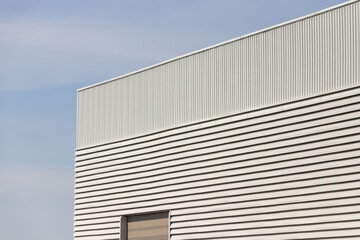 metal industrial building. steel cargo with blue sky background.