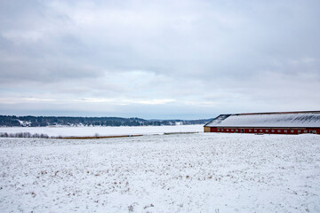 Sormalnd, Sweden A snowy and wintery  landscape with a farm.