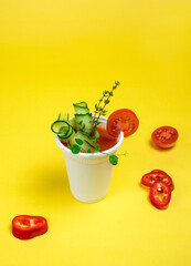 Take-out soup, vegetable soup in a glass, tomato soup. Soup to go