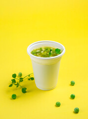 Take-out soup, vegetable soup in a glass, pea soup. Soup to go