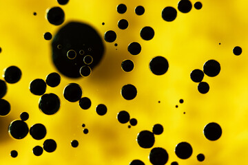 Black drops on yellow background