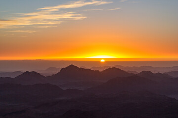 Naklejka na ściany i meble Sunrise at mount sinai summit. Road on which pilgrims climb the mountain of Moses. Egypt, Sinai, Mount Moses