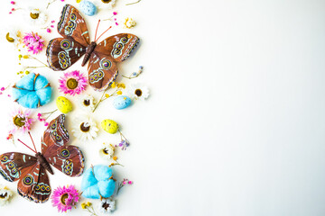butterflies, eggs, flowers, cotton on a white background easter theme. copy space . flat lay. 