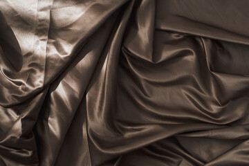 Brown atlas or silk fabric background, texture.