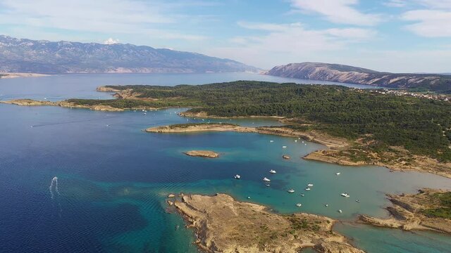 Aerial drone footage of the idyllic sandy beach of Ciganka of the Rab island in the Dalmatia region of Croatia in the Adriatic sea. 