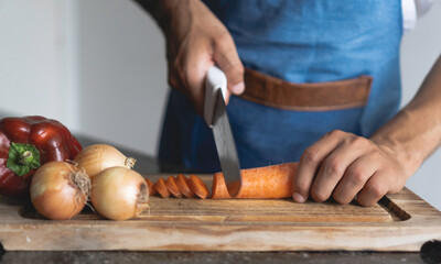man cuts vegetables with his hands