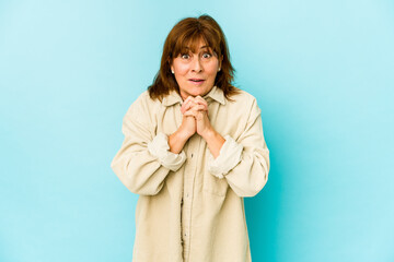 Senior caucasian woman isolated praying for luck, amazed and opening mouth looking to front.