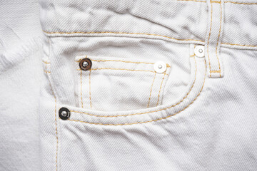 White jeans front pocket. Denim texture of white jeans background, classic jeans.