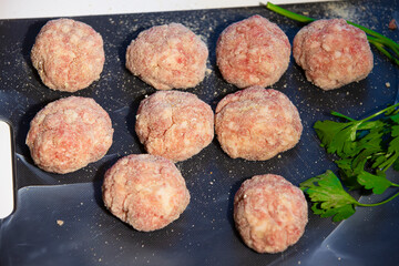 Cooking meat cutlets. Semi-finished meatballs on a cutting board.