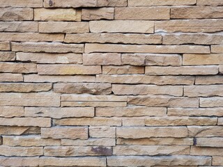 The wall decorated with small pieces of sandstone arranged together.