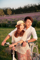The young couple riding a bicycle
