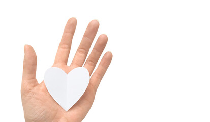 White paper heart in a female hand isolated on a white background
