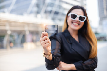 Fototapeta premium Close up credit card use instead of cash showing by woman,