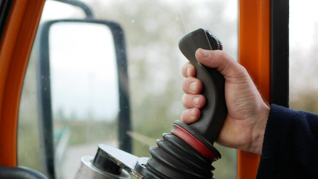Male Hand Controls Joystick of Excavator Machine