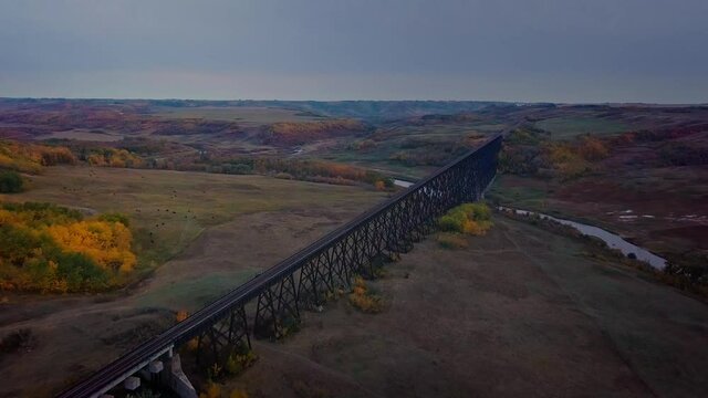 Flying towards historic train trestle bridge and expansive Battle River valley.