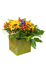 Flower decoration background. Close-up of a beautiful bouquet with yellow sunflowers in a decorative green gift box isolated on a white background. Macro.