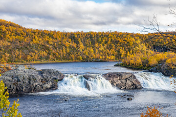 Waterfall in a wild and yellow landscape in Norway