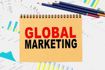 TEXT GLOBAL MARKETING. Office workplace with supplies and reports. You can use in business, marketing and other concepts. Messege of the day.