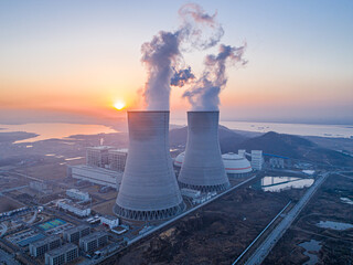 Nuclear power plant after sunset. Dusk landscape with big chimneys.At dusk, the thermal power...