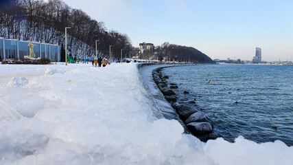 Winter walk. People walking on the Baltic sea boulevard in Gdynia, Poland. Gdynia is an important...