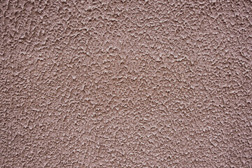 Close-up image of rough textured wall surface with plaster splashes pattern