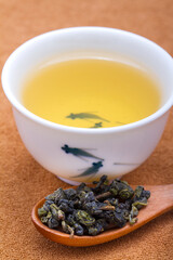 A cup of oolong tea with dried tea leaves,close-up