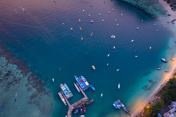 passenger parking shipping in high season on phi phi island kra bi Thailand aerial top view at twilight .