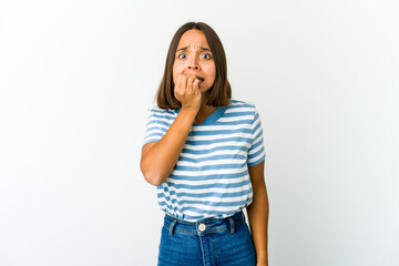 Young mixed race woman biting fingernails, nervous and very anxious.