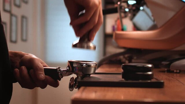 Step by step training from scratch how to prepare tasty coffee. Pressing. Hands prepare espresso. Close up view. 4k