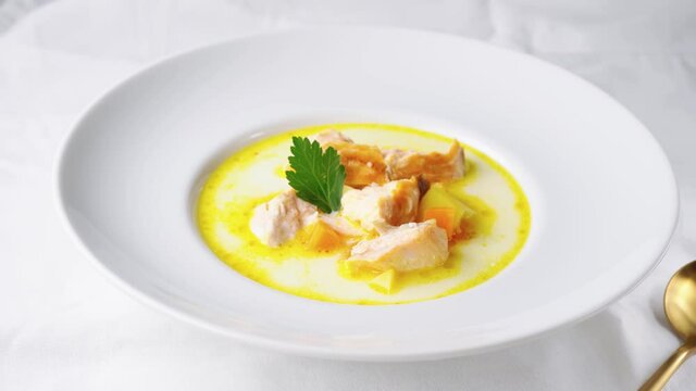 Healthy salmon cream soup into white plate