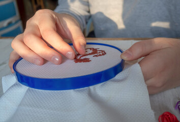 The process of embroidery.Hands with embroidery frame. Handmade, hobby.
