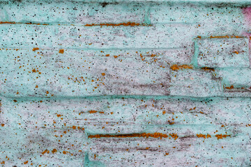 Background with a wall structure covered with large granite stones close-up, overgrown with moss