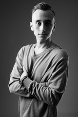 Portrait of young handsome man against gray background