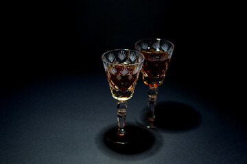 wine glasses with alcohol on a black background