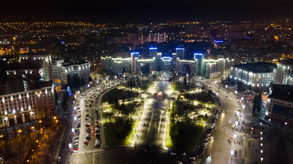 Fototapeta na wymiar Aerial night view with illumination lights of Derzhprom and Karazina National University on Freedom Svobody Square Kharkiv, Ukraine