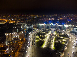 Fototapeta na wymiar Aerial night view with holidays illumination lights of Derzhprom and Karazina National University on Freedom Svobody Square Kharkiv, Ukraine