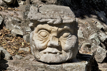 Obraz premium Copan, Honduras, Central America: Carved old man head. Copan is an archaeological site of the Maya civilization, not far from the border with Guatemala