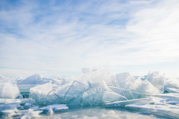 Fototapeta na wymiar Hummocks on the lake. Ice in sunny day on the Kapchagai reservoir in Kazakhstan