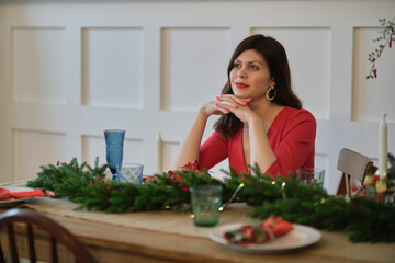 Portrait of a beautiful young brooding brunette woman. Beautiful young pretty woman bright evening makeup of shiny red lipstick. elegant suit red trousers blouse jacket high heels clothes for party.