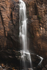 Fototapeta premium Nuwara Eliya, Sri Lanka. March 2020. Beautiful landscape with a waterfall. Vertical frame