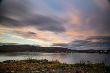 Shore of Tromsø during sunset with mountains in the background