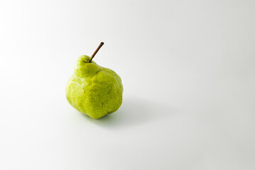 The strange green pear on a white background